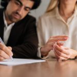 Cropped,Shot,Of,Sad,Spouses,Couple,Signing,Decree,Papers,Getting