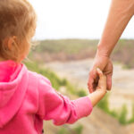 Daughter,In,A,Pink,Hoodie,Holding,Dad's,Hand,,Standing,On