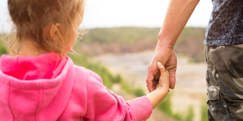 Daughter,In,A,Pink,Hoodie,Holding,Dad's,Hand,,Standing,On