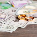 An,Old,,Crumpled,Dollar,And,A,Small,Children's,Toy.,Alimony,
