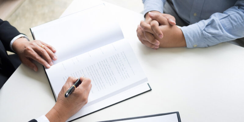 Business,People,And,Lawyers,Discussing,Contract,Papers,Sitting,At,The